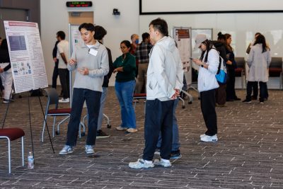 students attend a research poster session at the Graduate Life Center